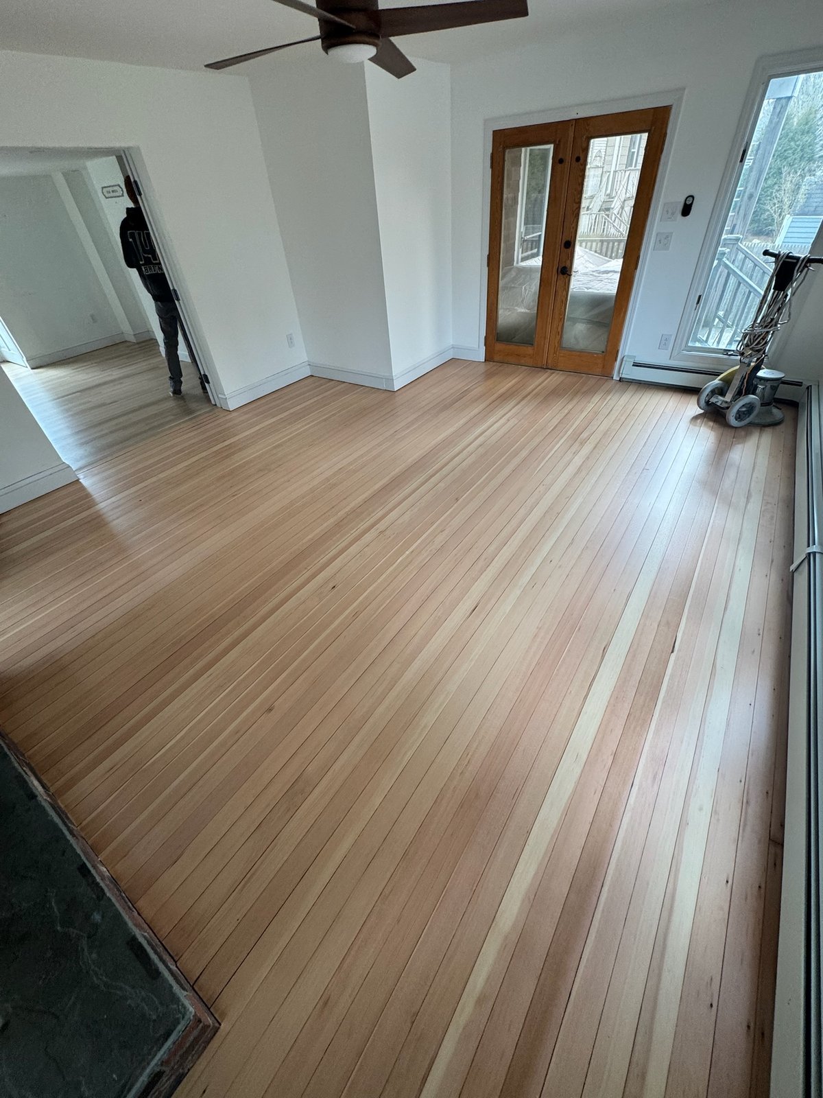 Middletown RI — sanding in progress with floor sander in frame during whole-house refinish