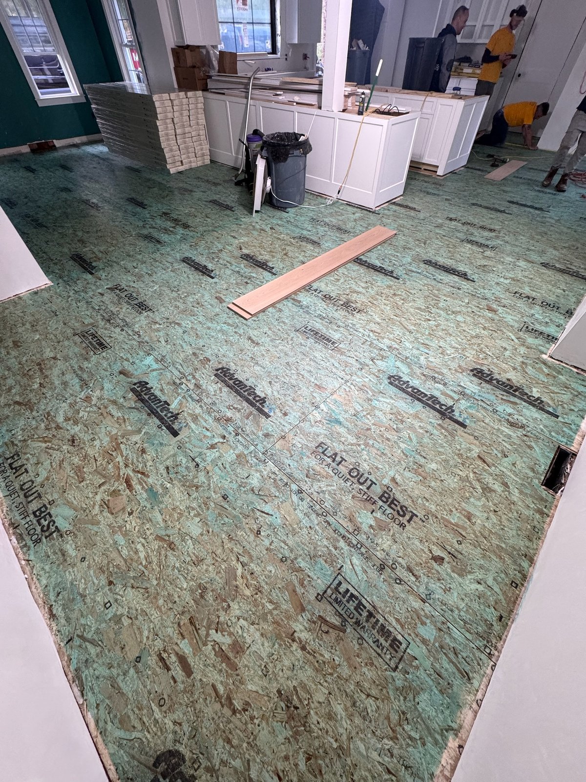 North Kingstown RI — subfloor preparation with crew on site before wide-plank installation