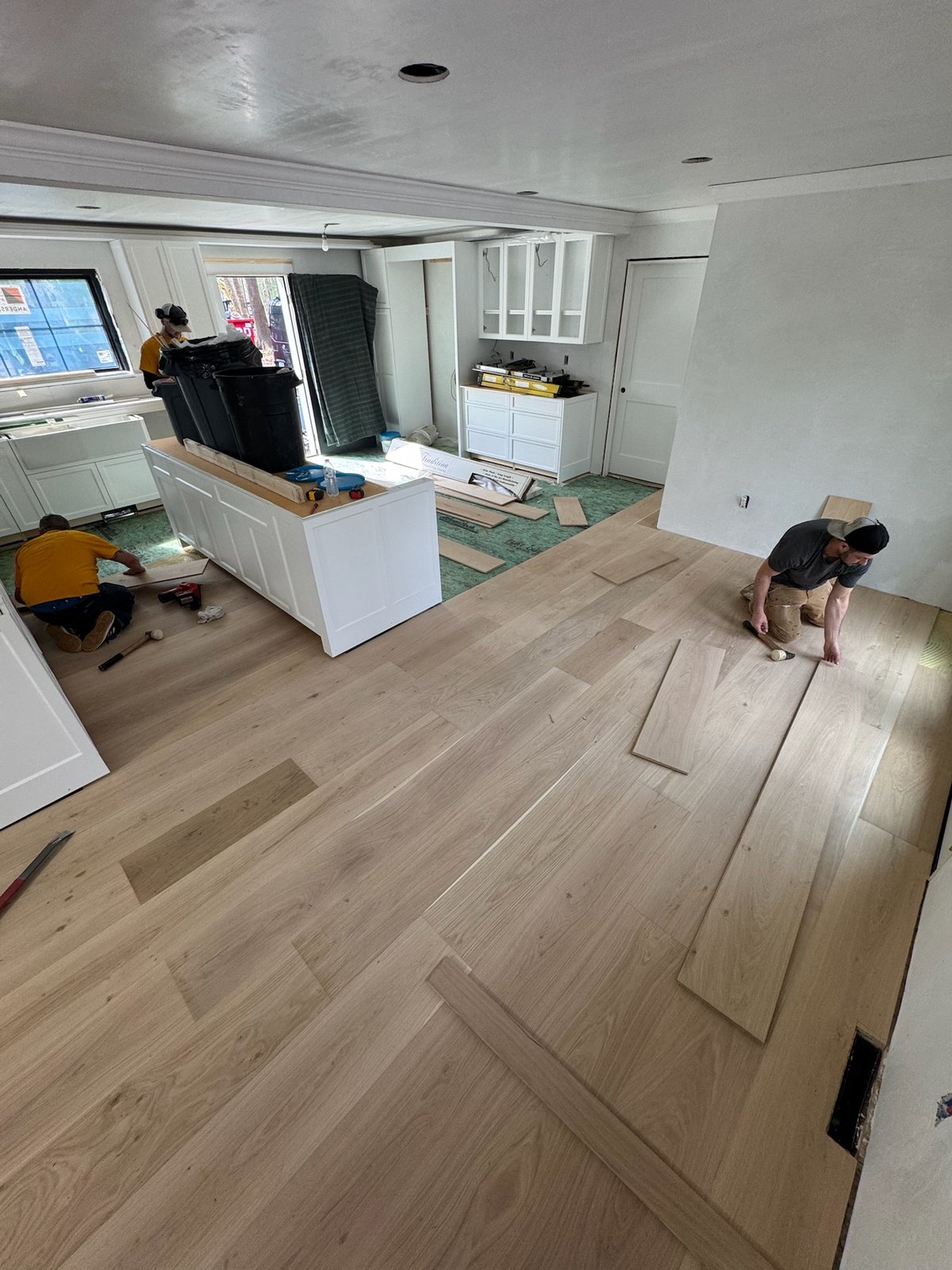 North Kingstown RI — 10-inch European white oak planks laid into adhesive during installation