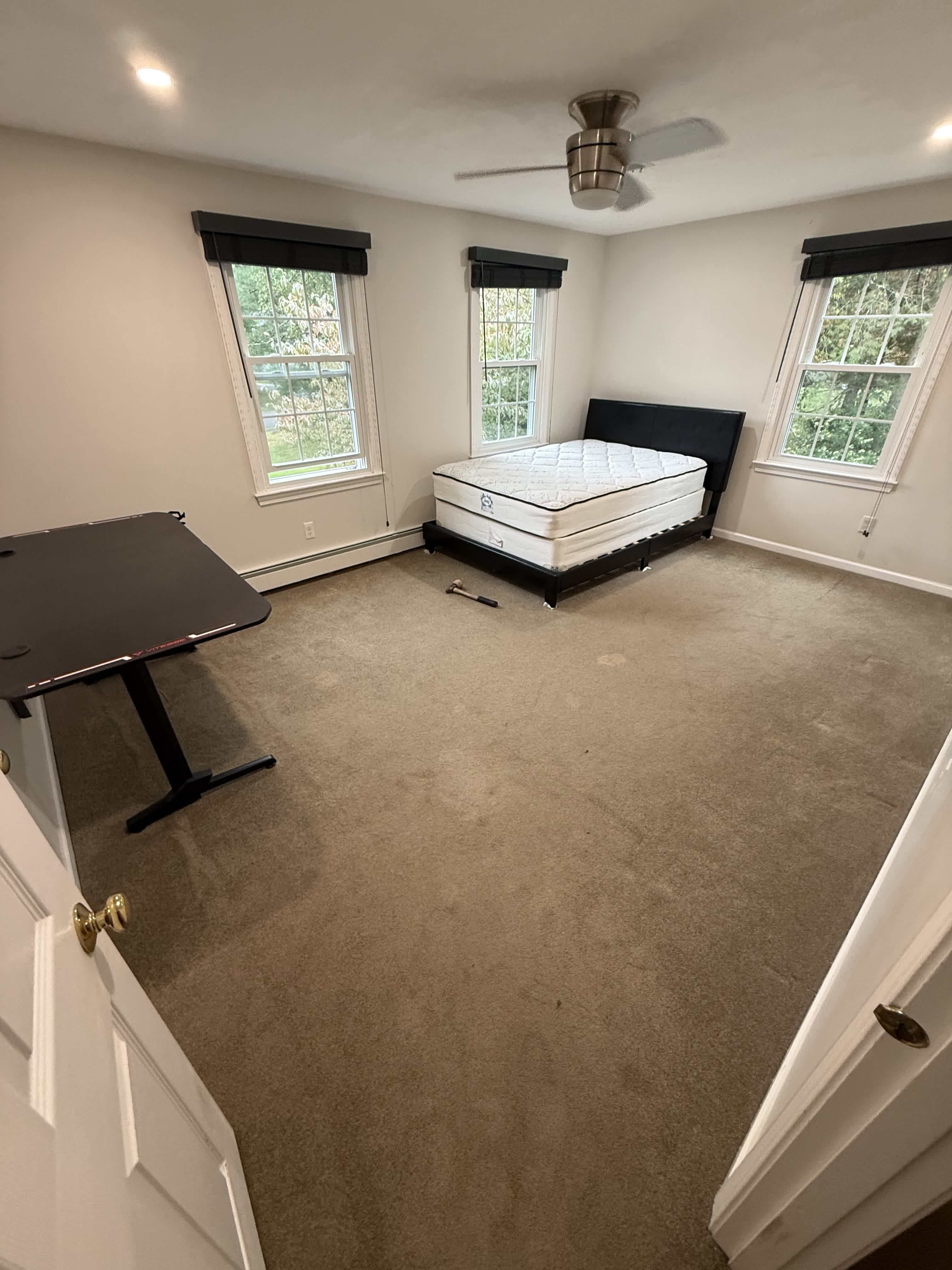 Wrentham MA — larger bedroom with original carpet before prefinished red oak installation