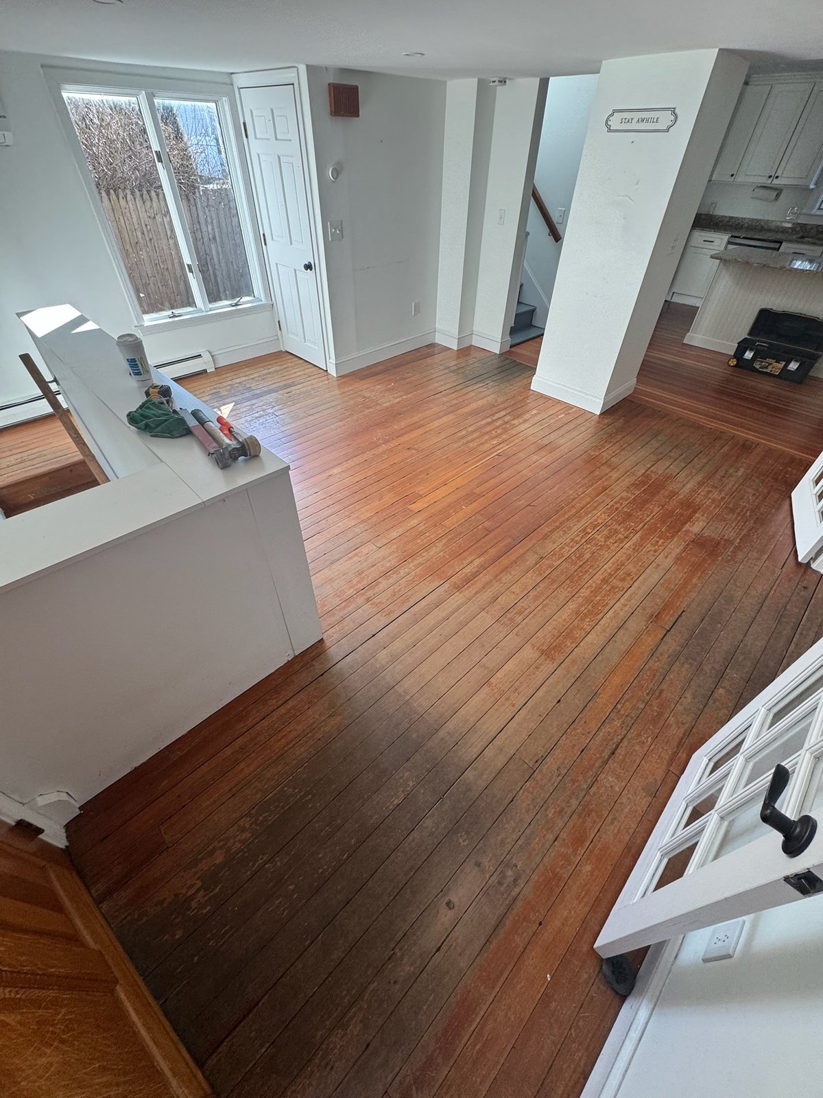 Middletown RI — sanding and pre-finish stage revealing the integration line between new white oak and existing heart pine