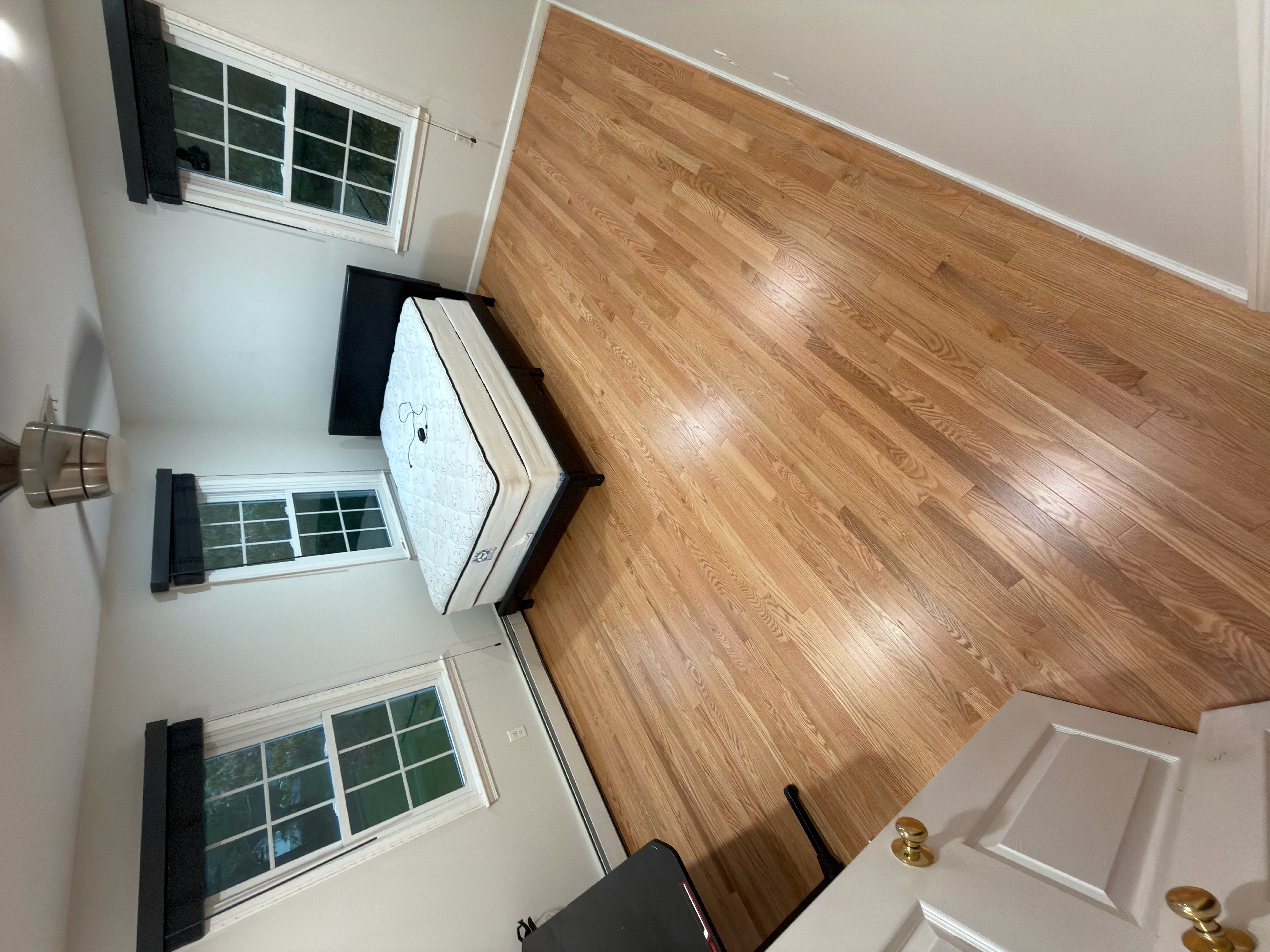 Wrentham MA — larger bedroom with new prefinished red oak floor complete, three windows and natural light