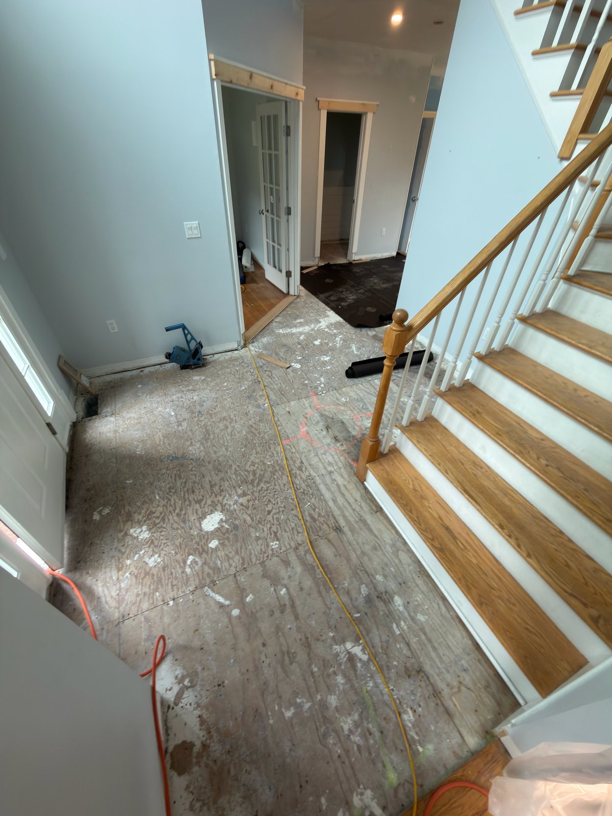 Portsmouth RI hardwood restoration — damaged section removed and plywood subfloor exposed during the restoration project