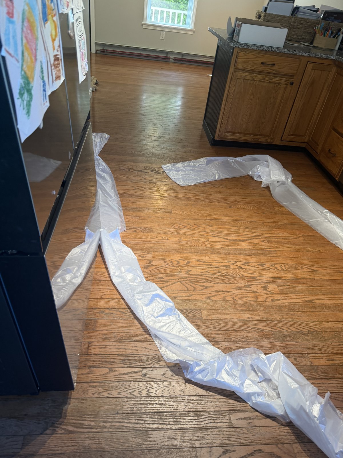 Coventry RI — worn prefinished hardwood kitchen floor before restoration, alternate angle