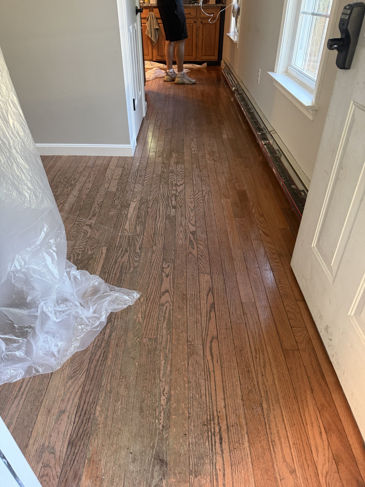 Coventry RI — worn prefinished hardwood hallway with scratches, stains and worn finish before restoration
