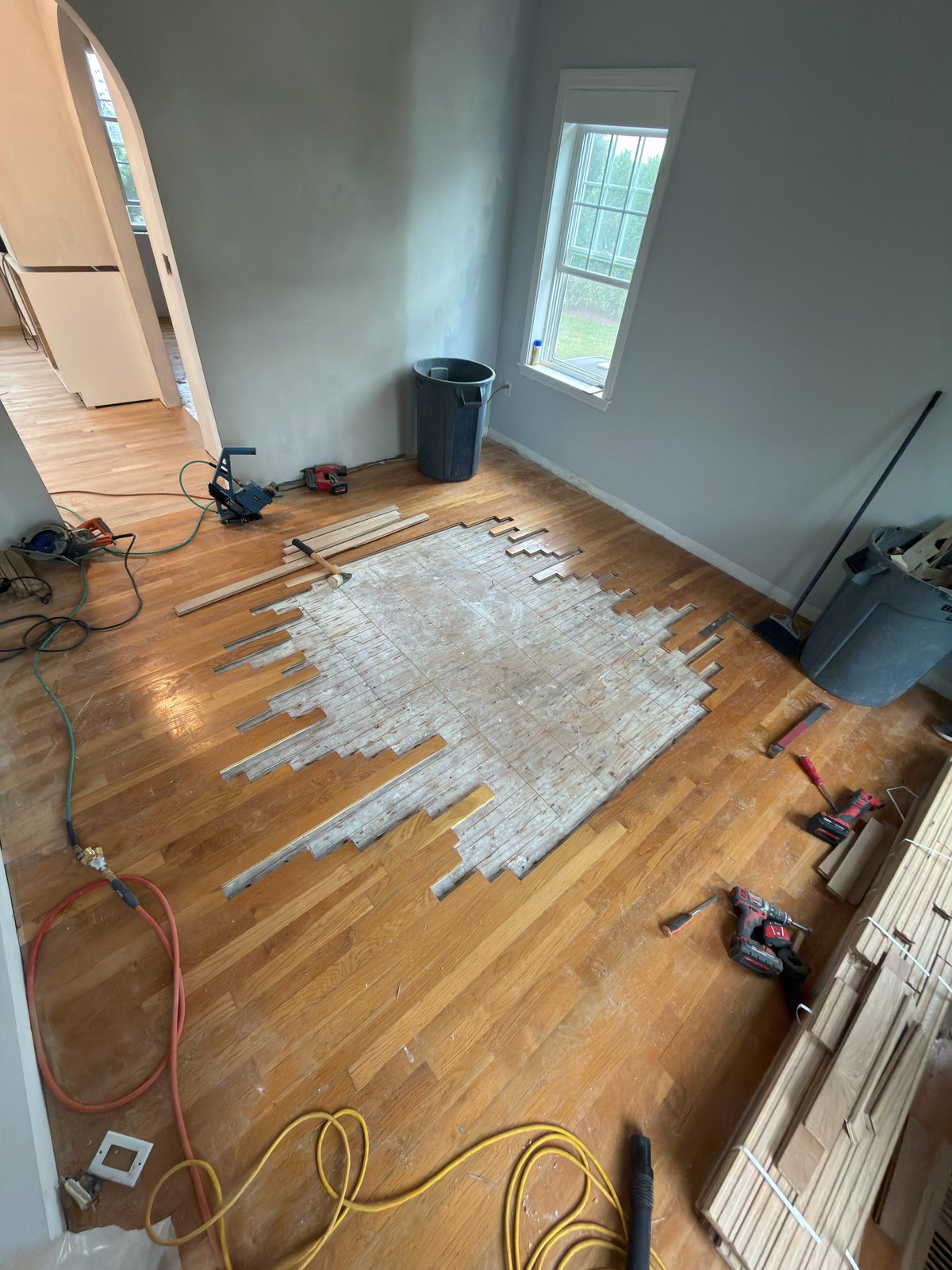 Portsmouth RI hardwood restoration — damaged boards removed and subfloor prepared for new white oak