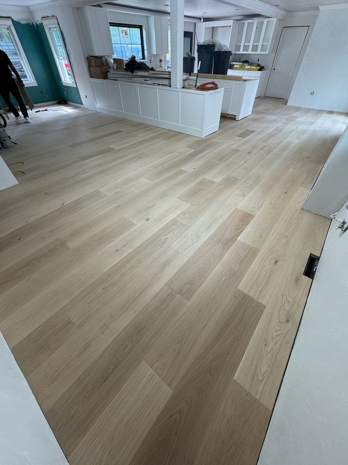 North Kingstown RI — raw installed wide-plank floor with sander and buffer on site before finishing