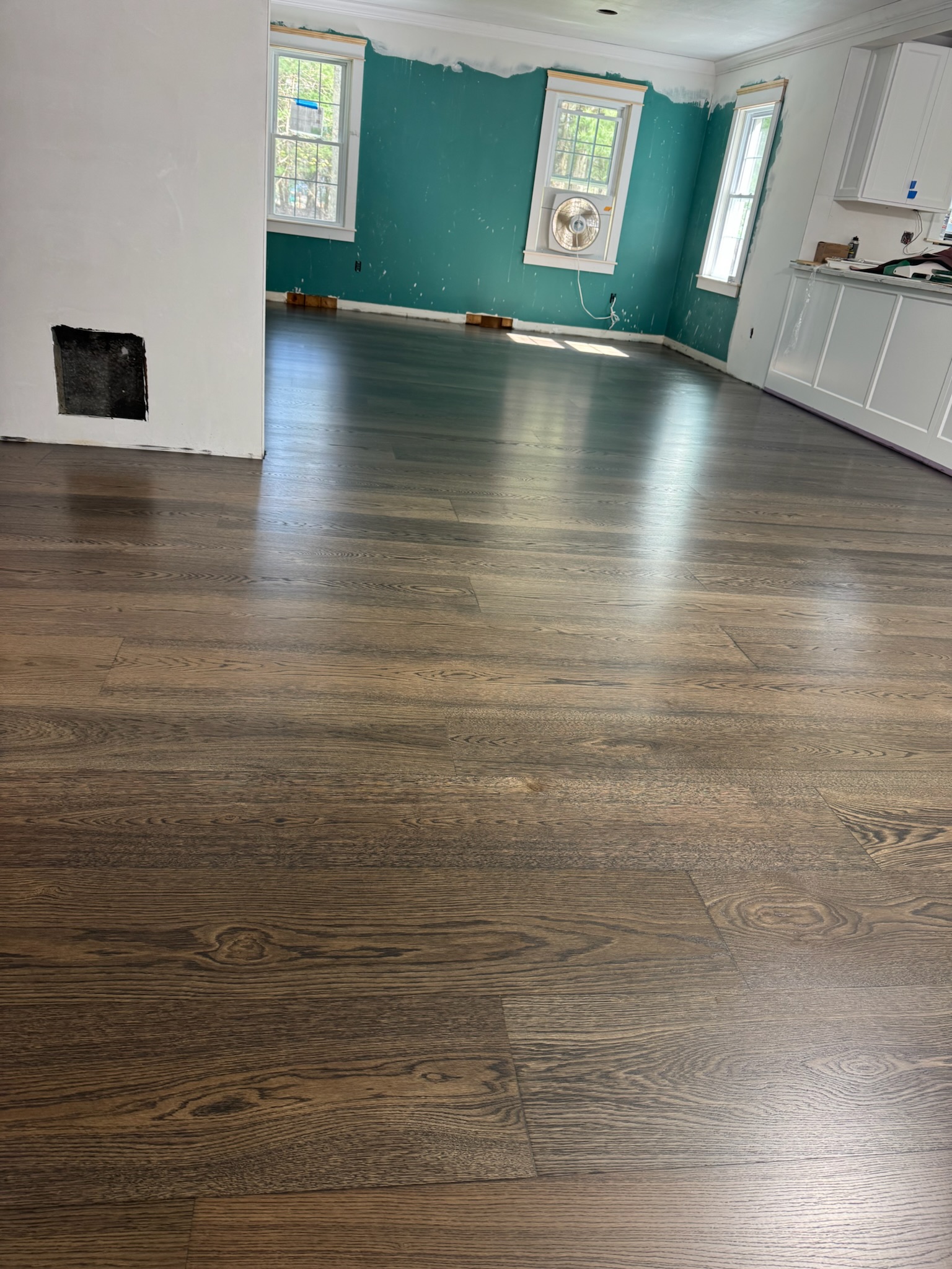 North Kingstown RI — finished 10-inch wide-plank European white oak floor with deep rich stain, open kitchen and living area