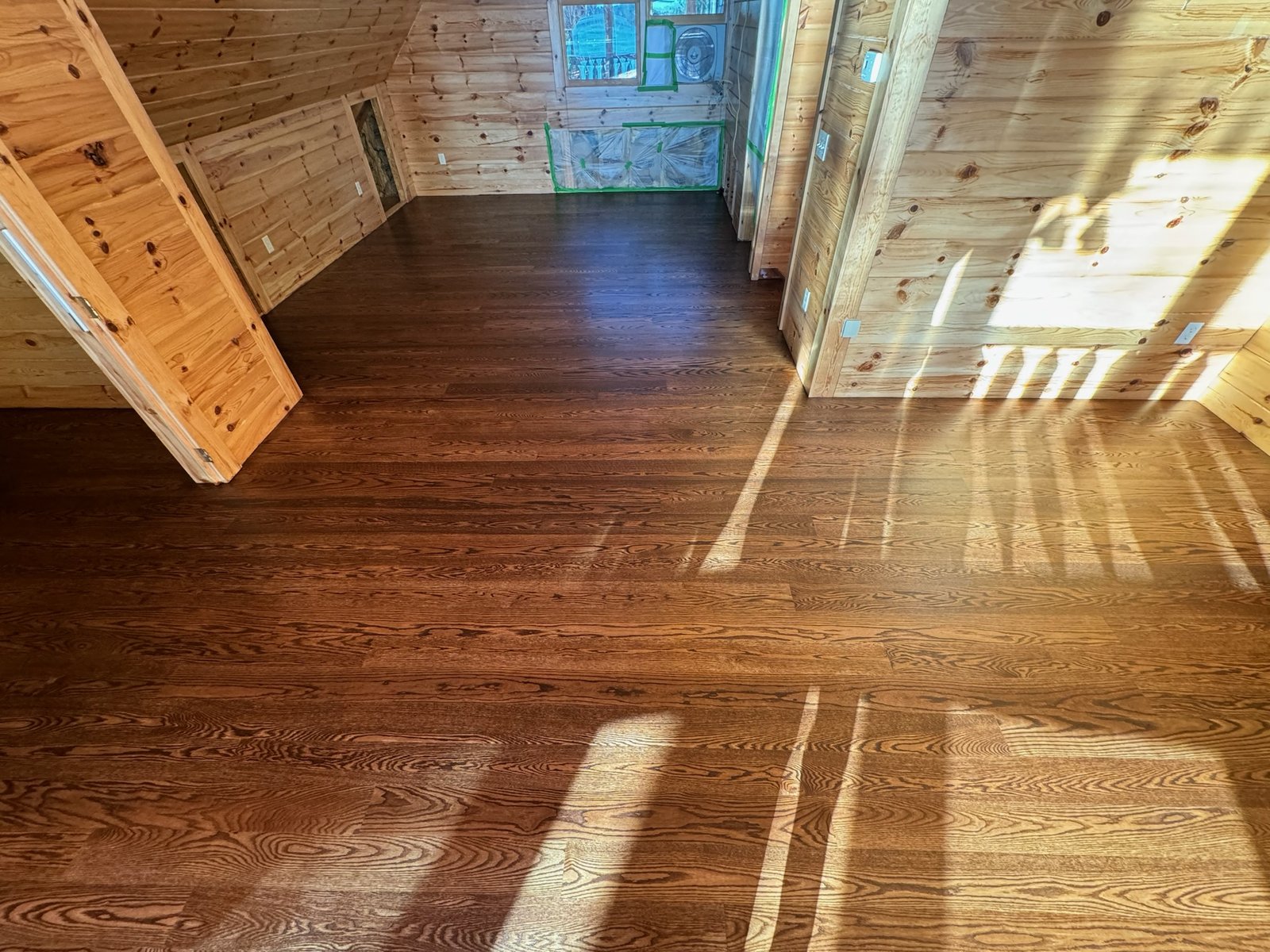 Killingly CT — finished A-frame room with dark stained hardwood floor after restoration