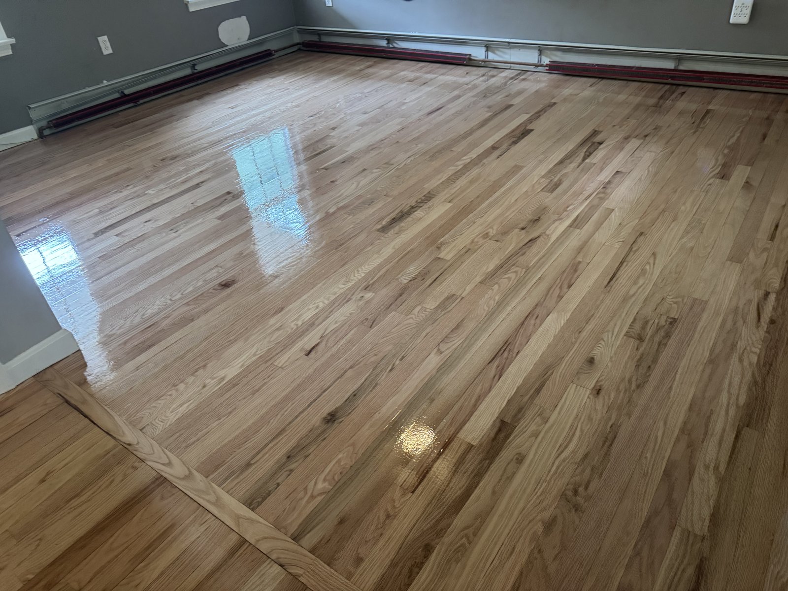 Coventry RI — freshly applied LOBA EasyPrime and 2K Duo finish on the prepared hardwood floor, glossy wet finish