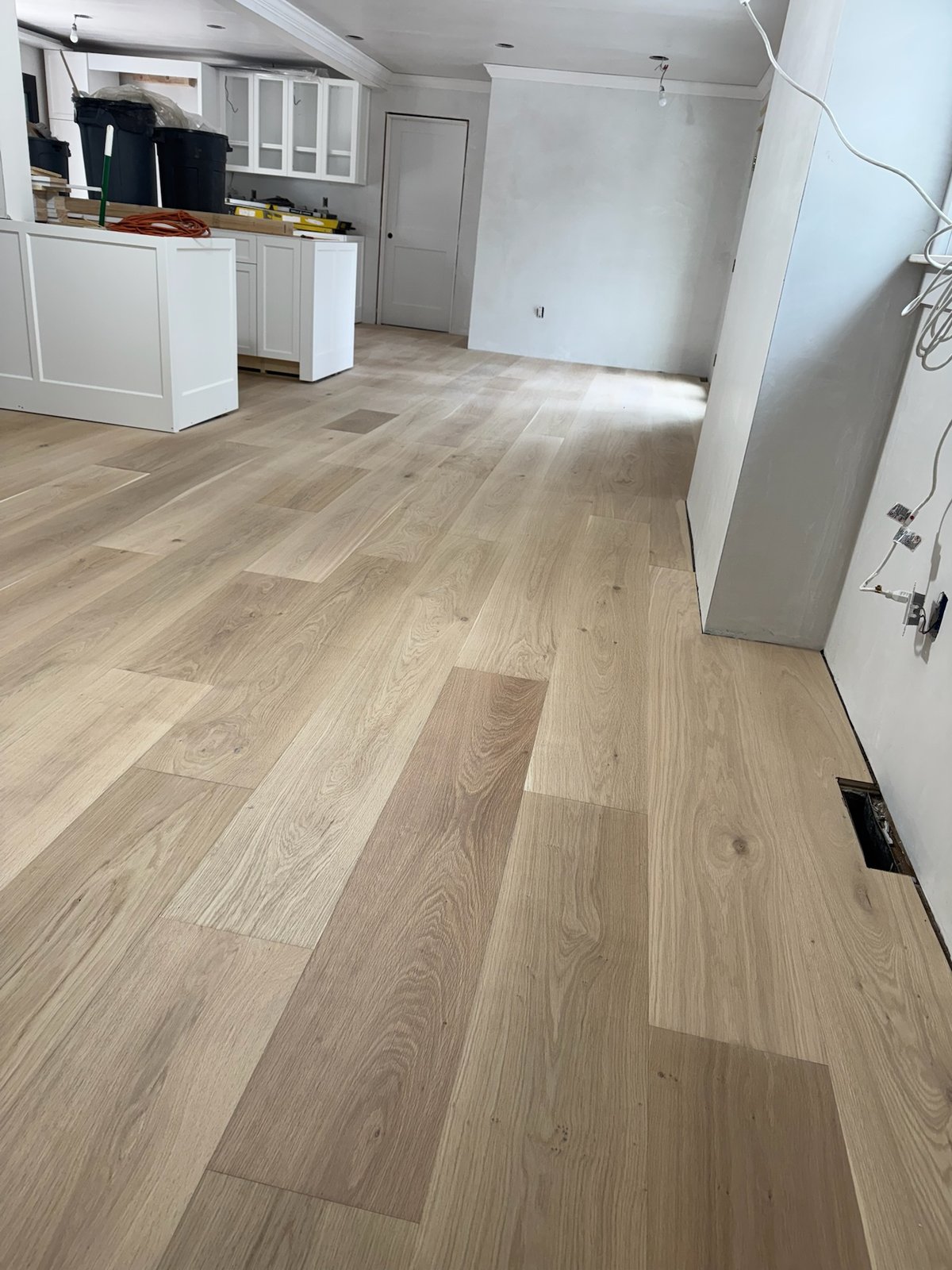 North Kingstown RI — raw installed wide-plank white oak floor before on-site finishing, angle three