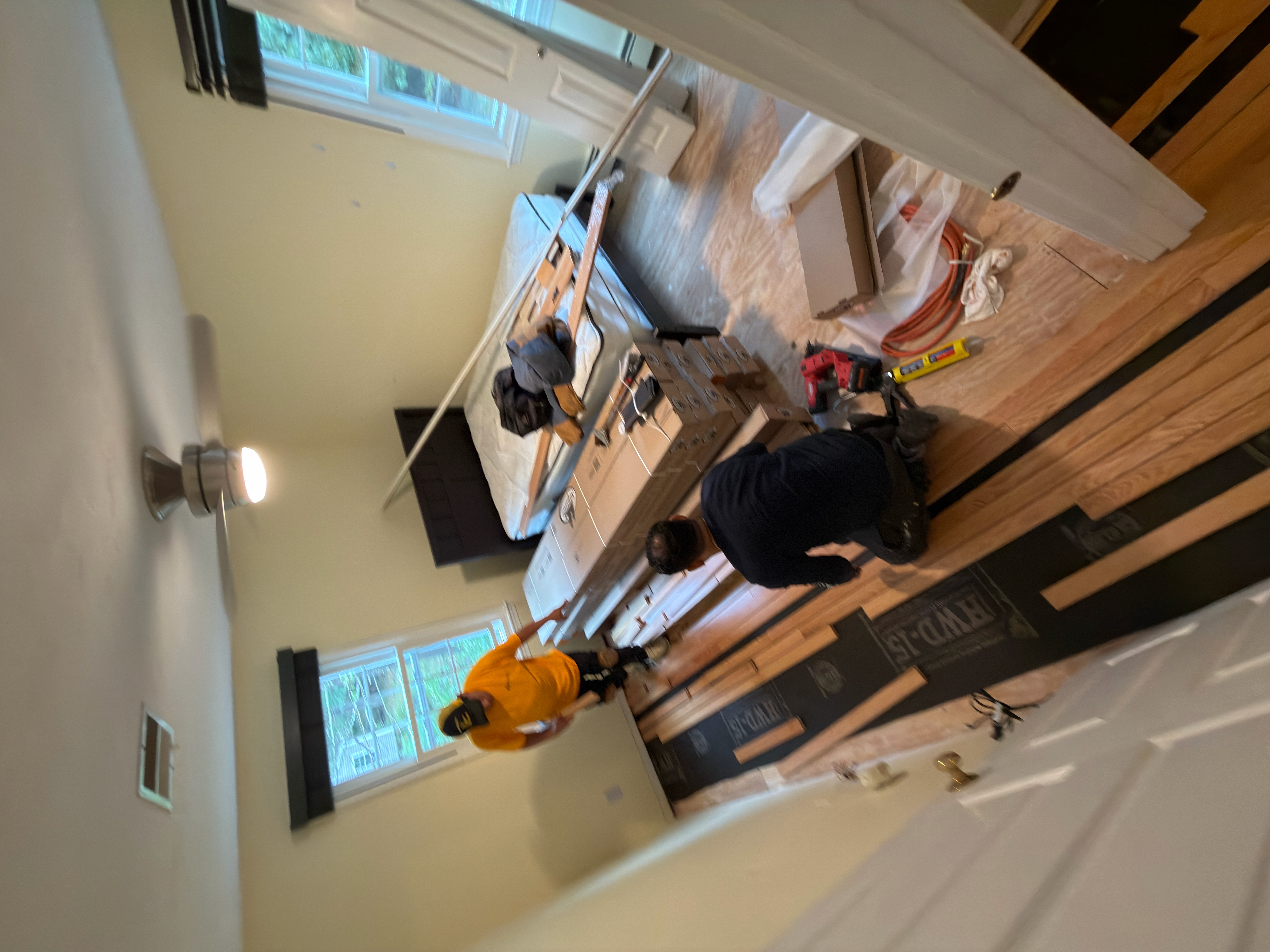 Wrentham MA — crew installing prefinished red oak hardwood with HWD underlayment in bedroom