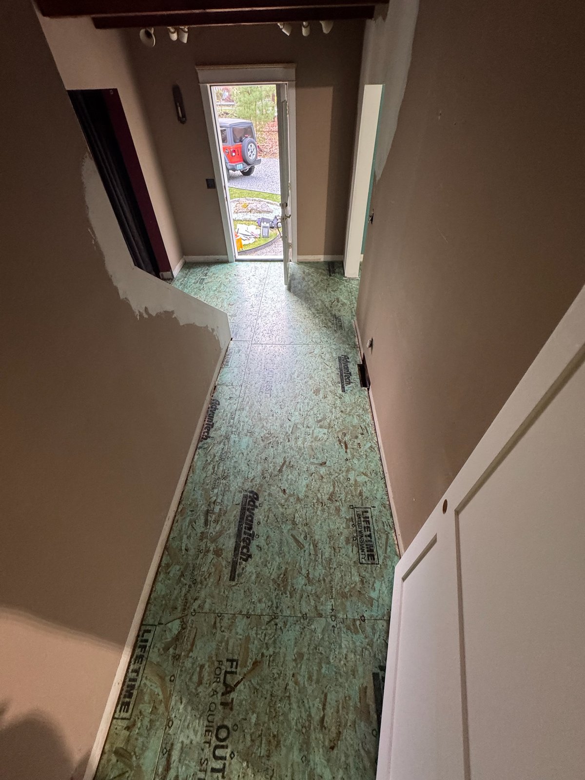North Kingstown RI — subfloor prepared in hallway before wide-plank white oak installation