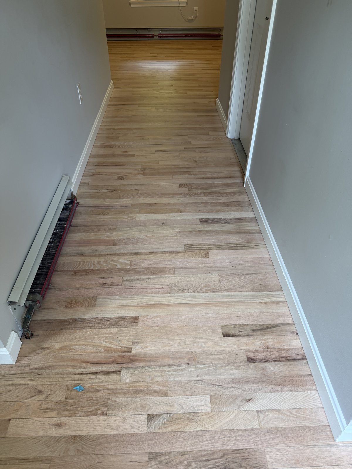 Coventry RI — raw sanded hallway floor after factory finish removal, ready for finish