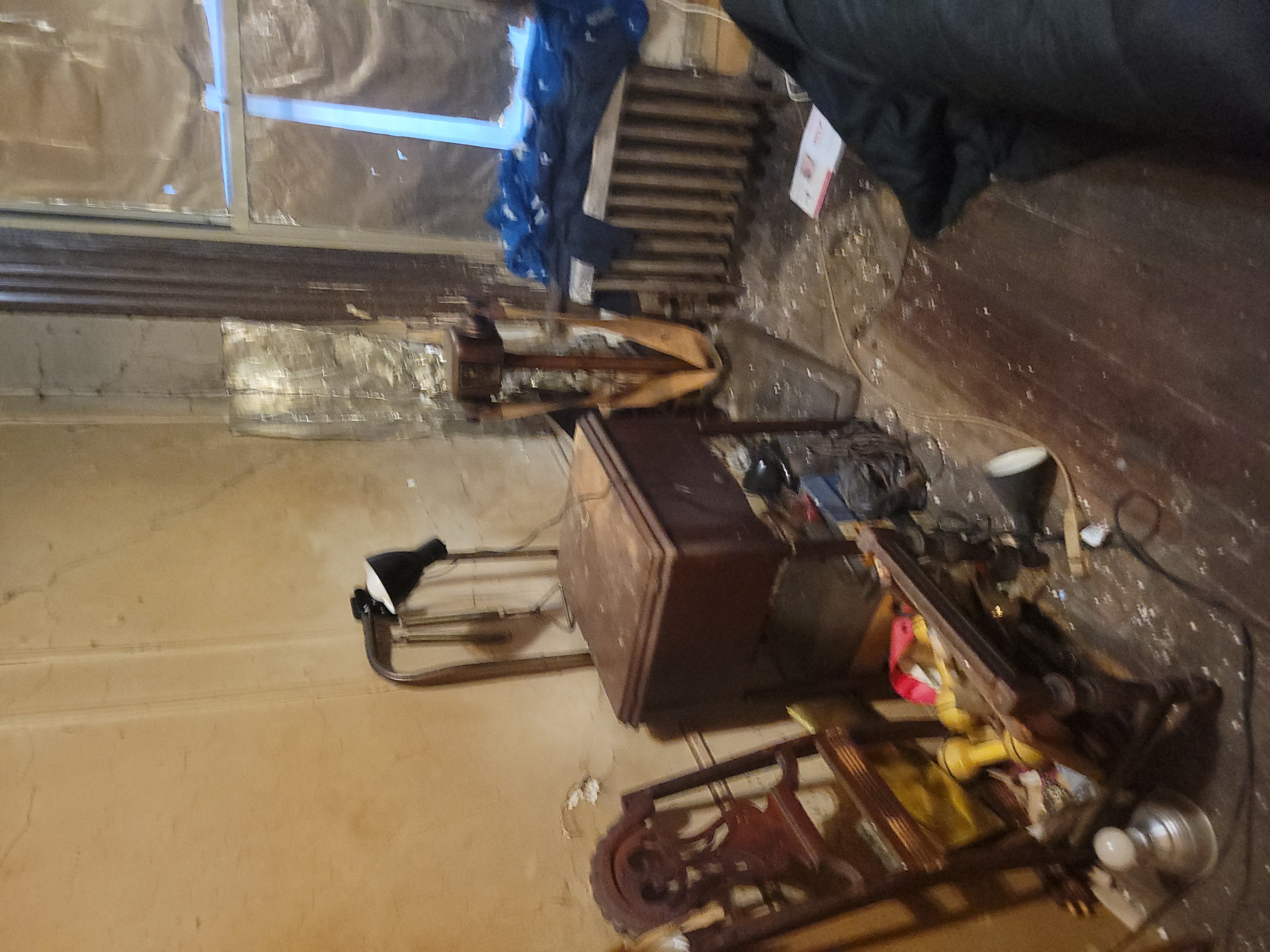 Apartment before deep clean - cluttered room with debris