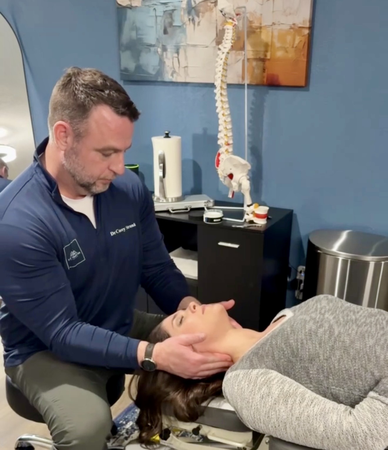 Dr. Corey performing a wellness consultation and neck adjustment