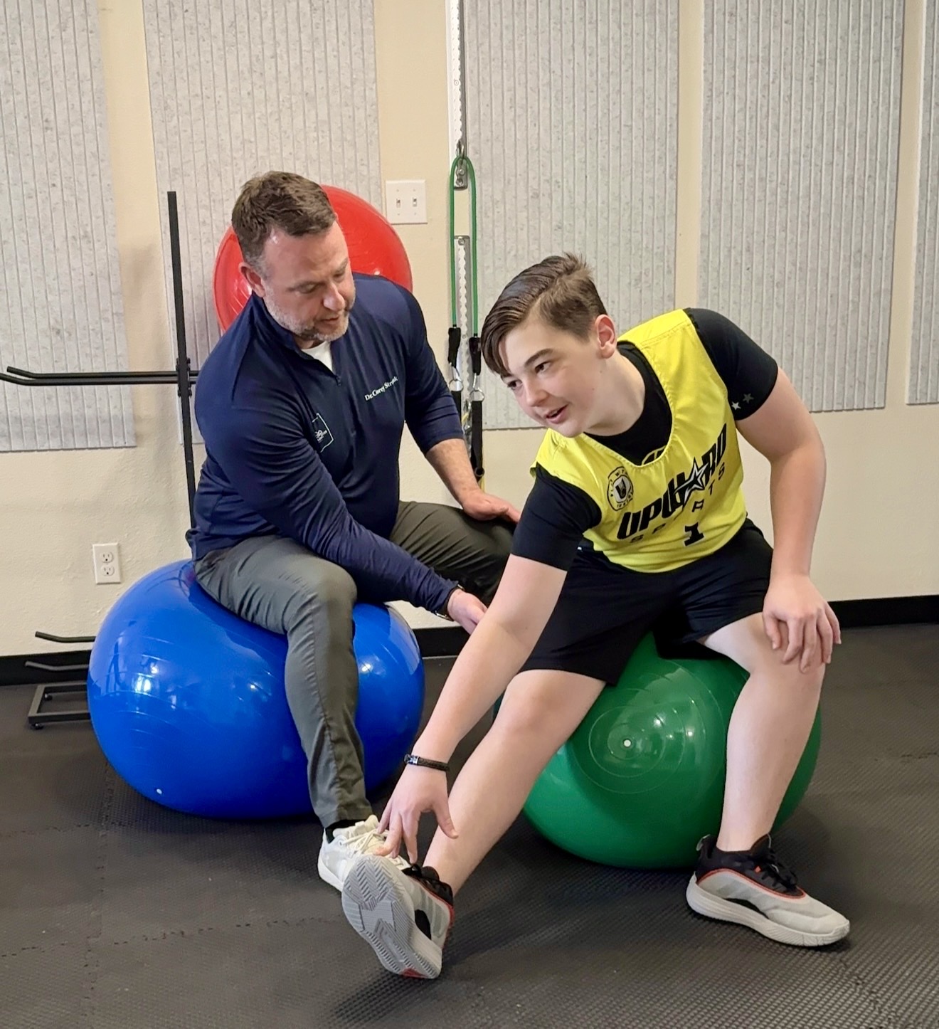 Dr. Corey working on posture correction with a young athlete