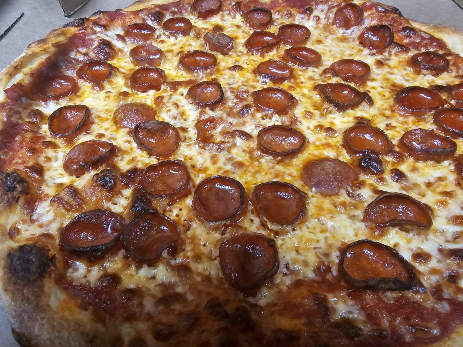 JoJo's pepperoni pizza — fresh out of the brick oven