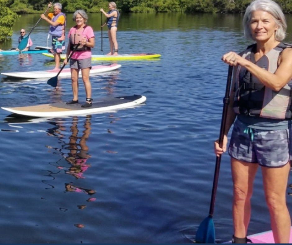 Seniors paddleboarding on Lido Key after acupuncture treatment for fibromyalgia at AcuMed Clinic Sarasota