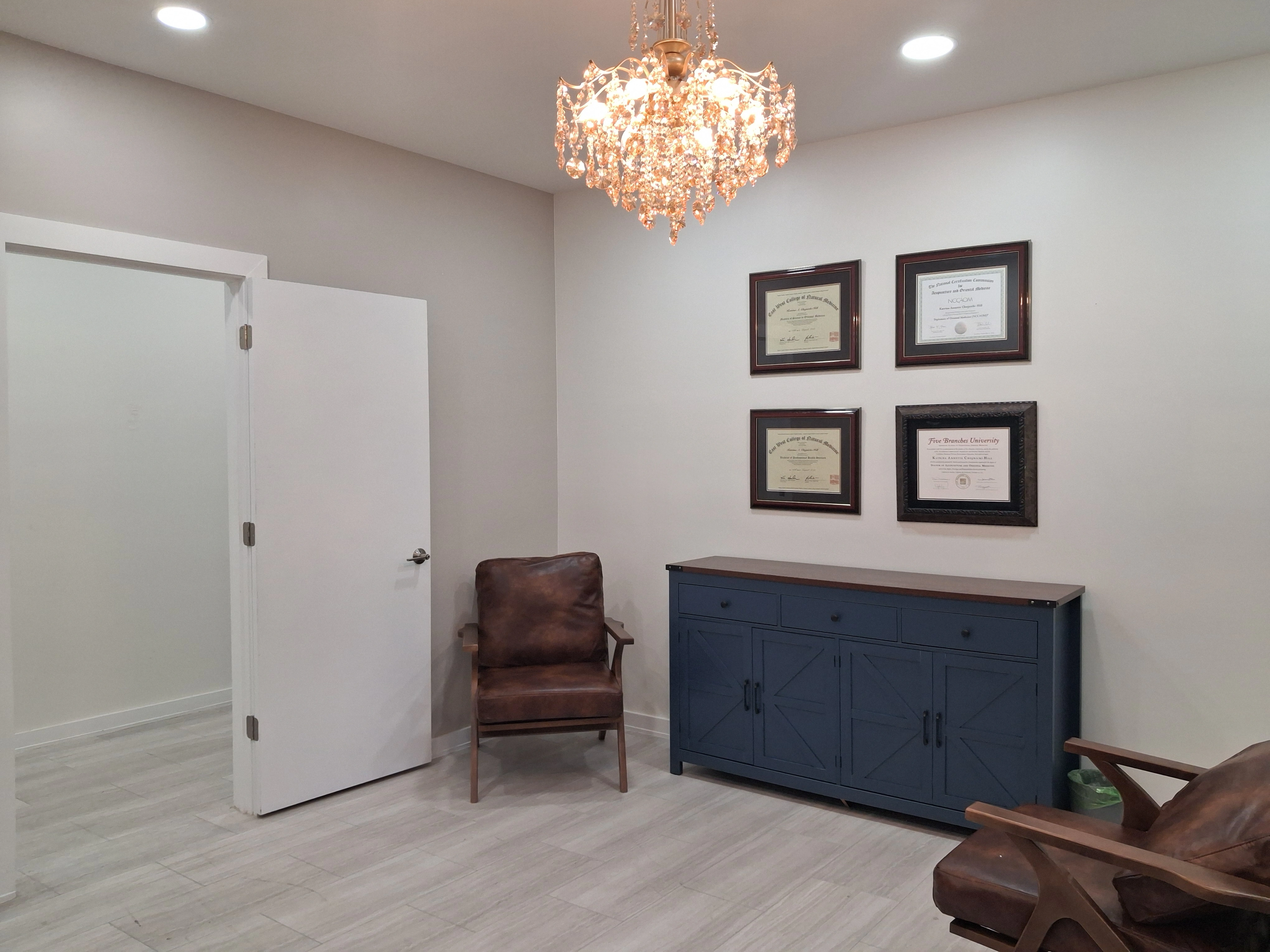 Waiting area at AcuMed Clinic with Dr. Kitt's credentials and diplomas displayed on the wall