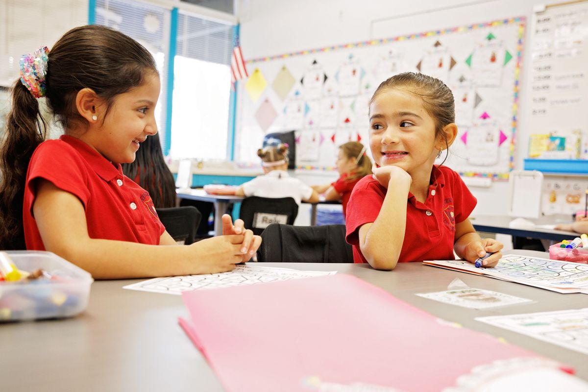 Two Valley Prep students talk and laugh during a classroom activity