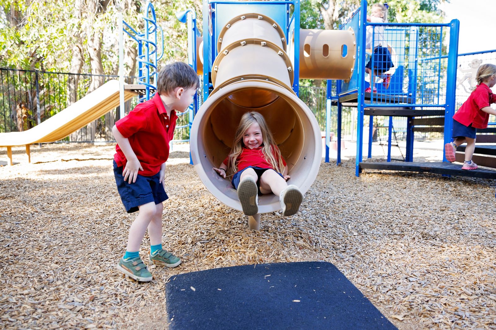 A Valley Prep student comes down the tube slide while a friend waits at the bottom