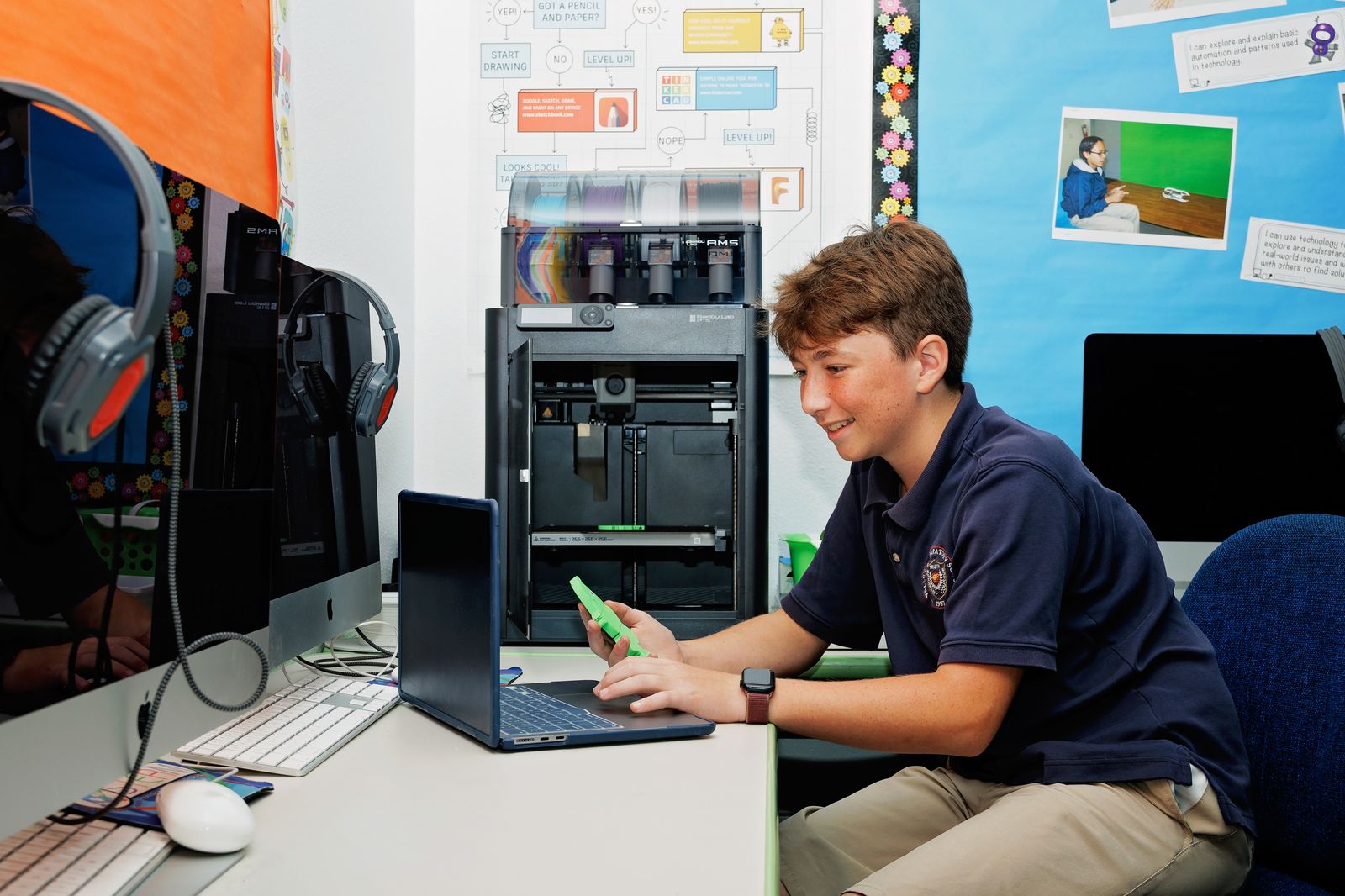 A Valley Prep student inspects a part he designed and printed on the STEAM lab 3D printer