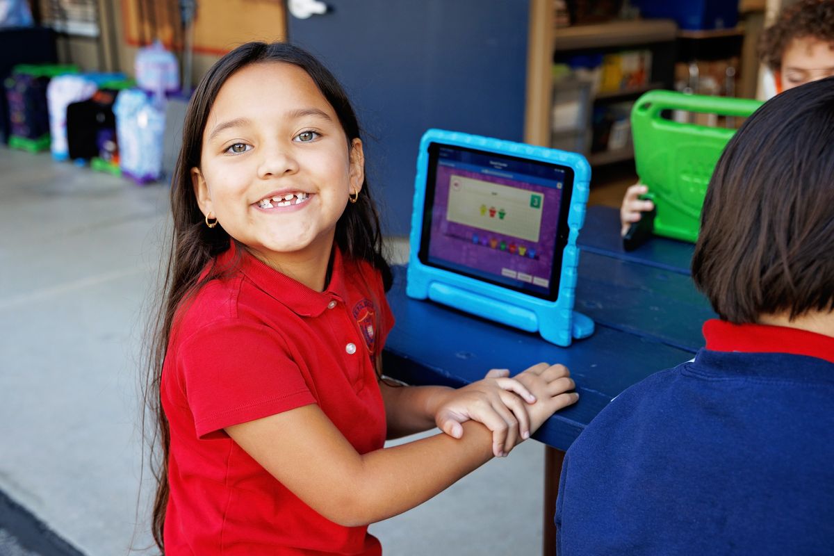 A Valley Prep student works through a math game on a tablet