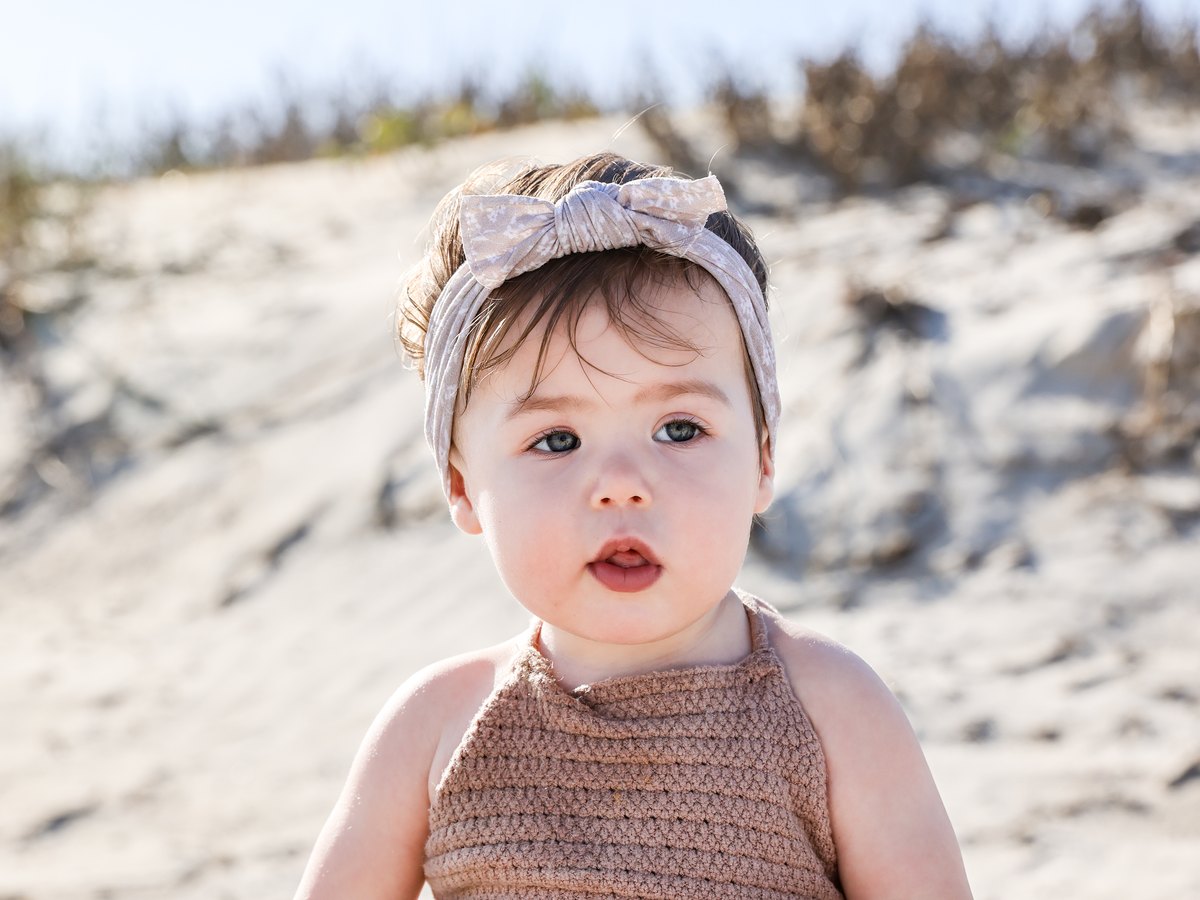 Close-up portrait of a baby on the beach