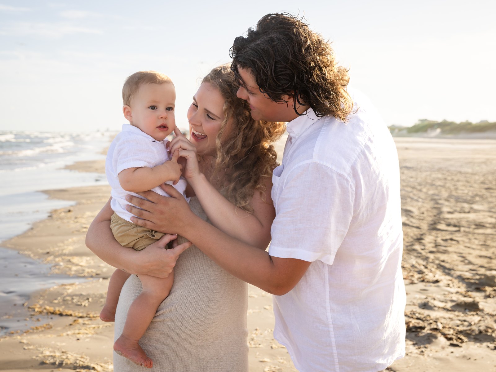 Family of three on the beach at golden hour