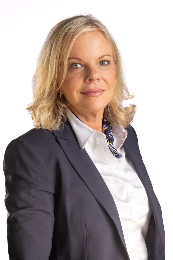 Professional business headshot of a blonde woman in a navy blazer and patterned scarf — Houston executive headshot