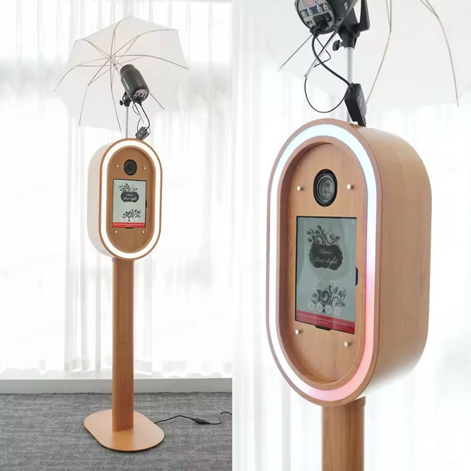 Professional photo booth operated by Nancy Hruby Creative Co. with wooden finish and professional strobe lighting