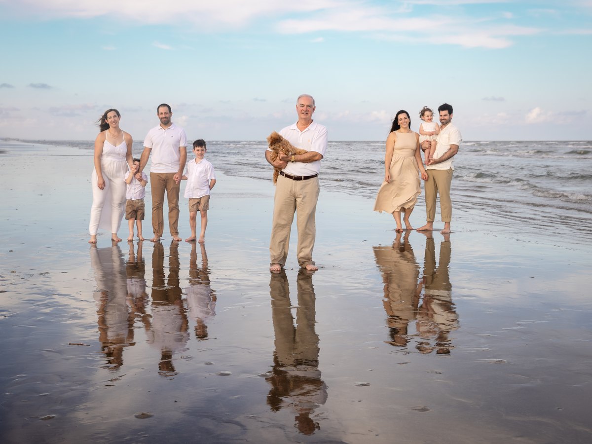 Extended family portrait on the beach with their dog