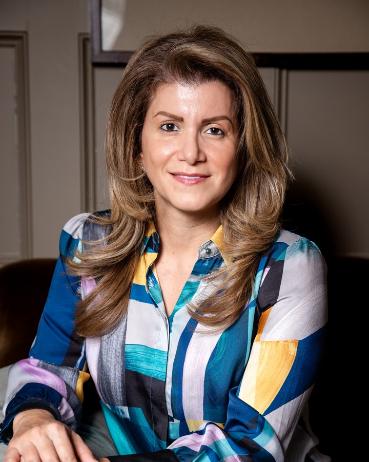 Personal branding headshot of a smiling woman in a vibrant abstract-print shirt — Houston branding portrait