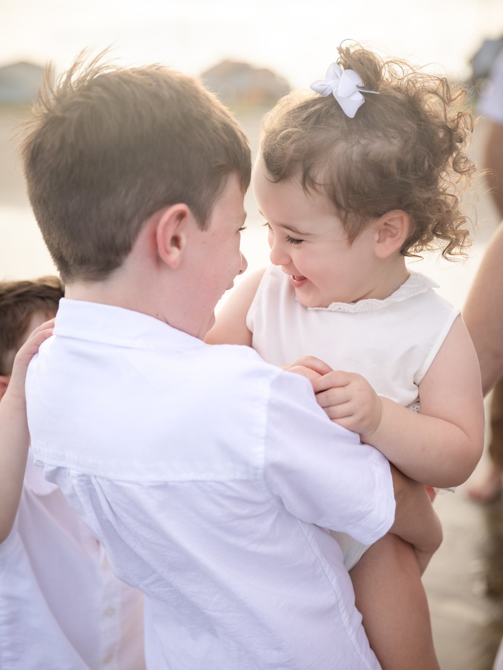 Two children sharing a moment together on the beach