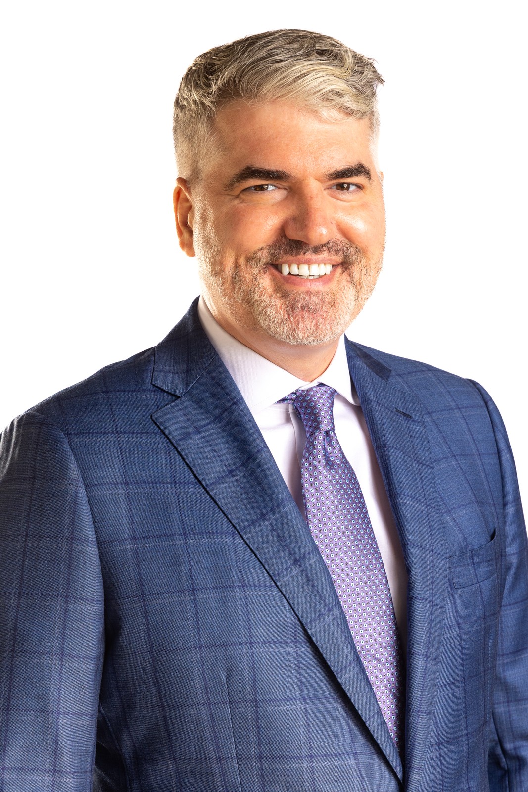 Professional corporate headshot of a smiling man in a blue plaid suit and purple tie — Houston headshot photographer