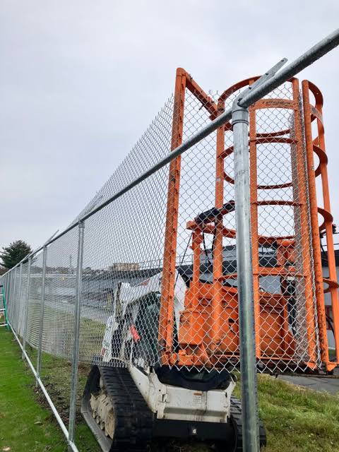 Commercial fence installation with heavy equipment