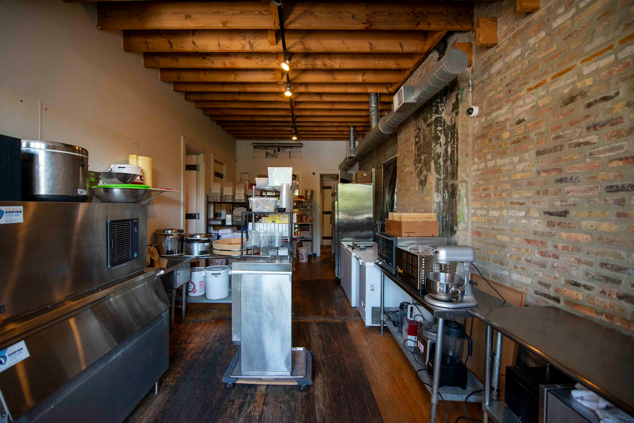 Commercial kitchen with stainless steel equipment, ice machine and stand mixer at 1829 W Chicago Ave