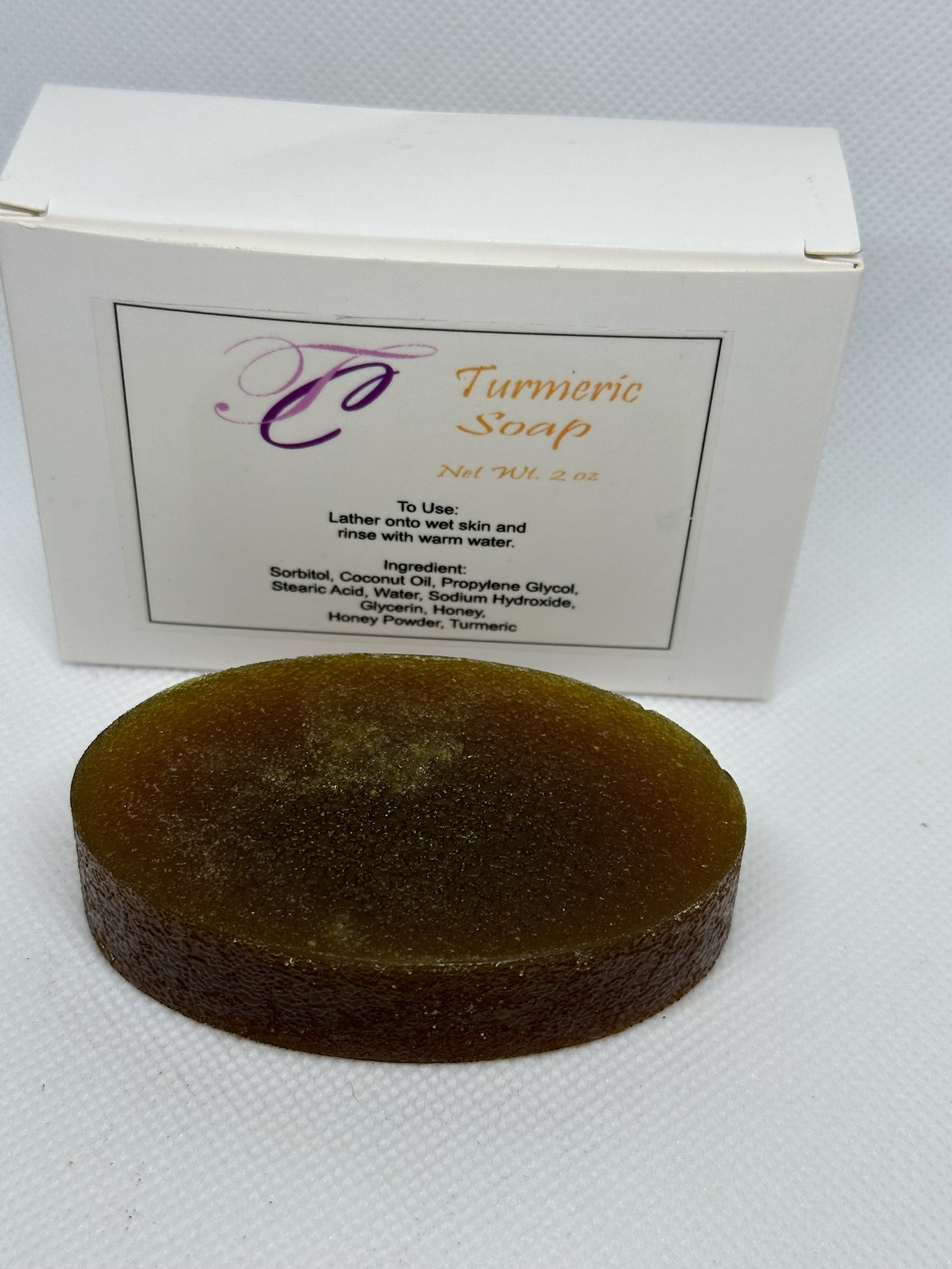 Tigress Creations Turmeric Soap — real product photo showing the golden handcrafted bar with branded packaging