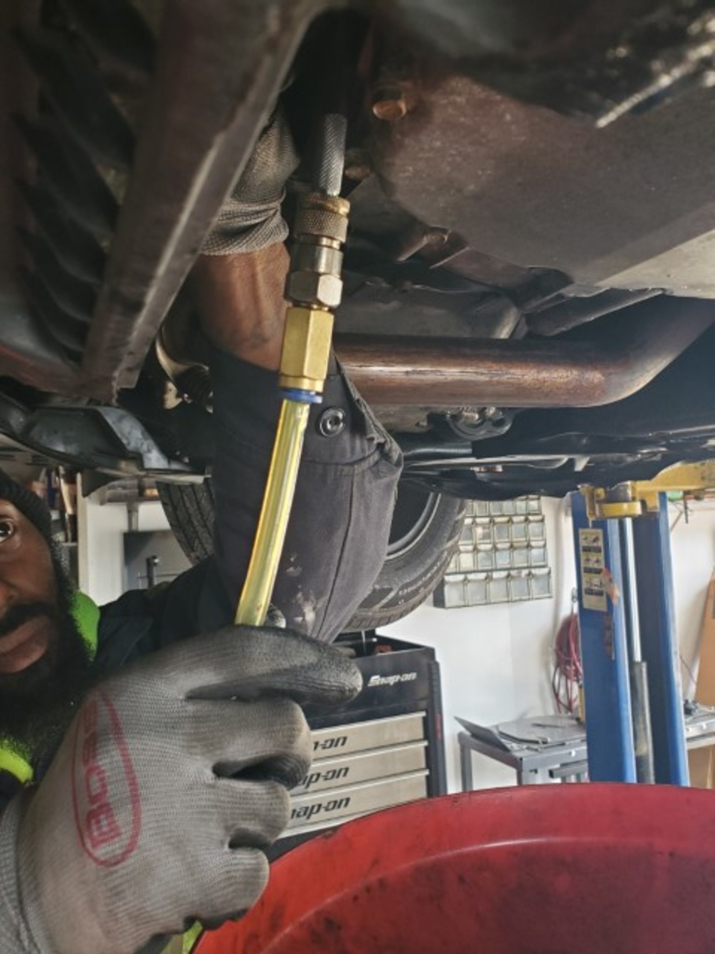 SAP Auto Repair technician working under a vehicle