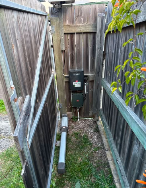 Same-day swing gate motor repair: battery replacement and limit reset in Logan Central.