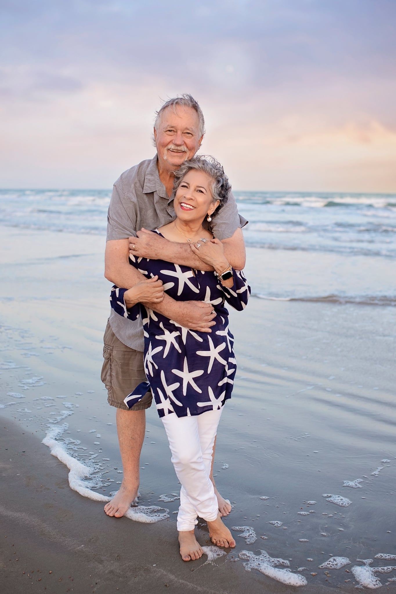 Couple embracing on Galveston beach at sunset