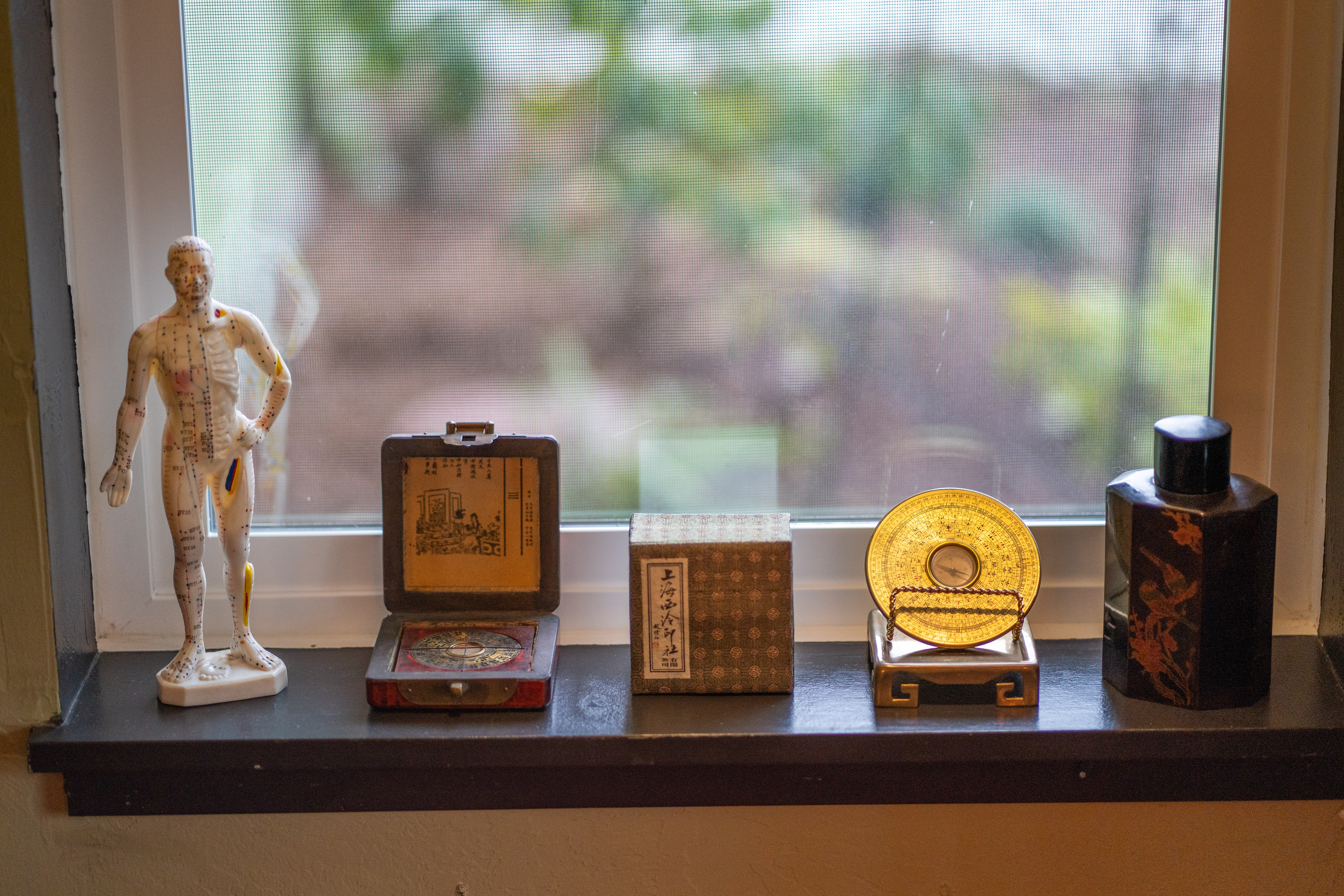 Acupuncture and Chinese medicine objects on a clinic windowsill in Ashland, Oregon