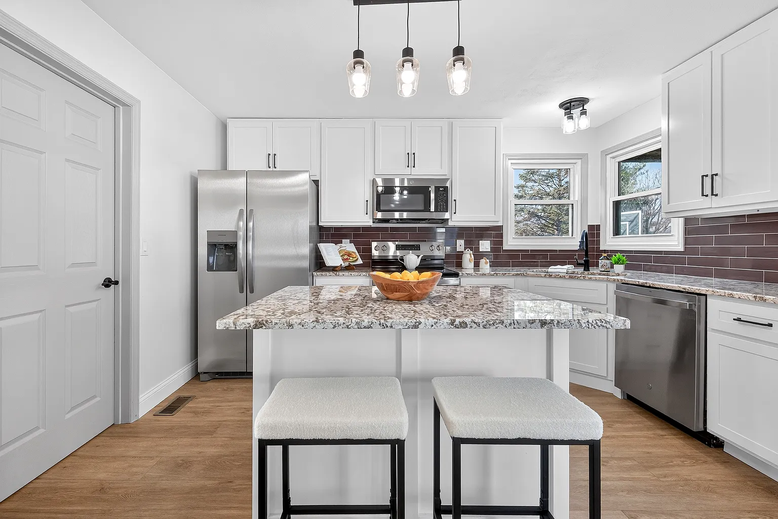 Modern kitchen remodel in St. Louis with white cabinets and quartz countertops