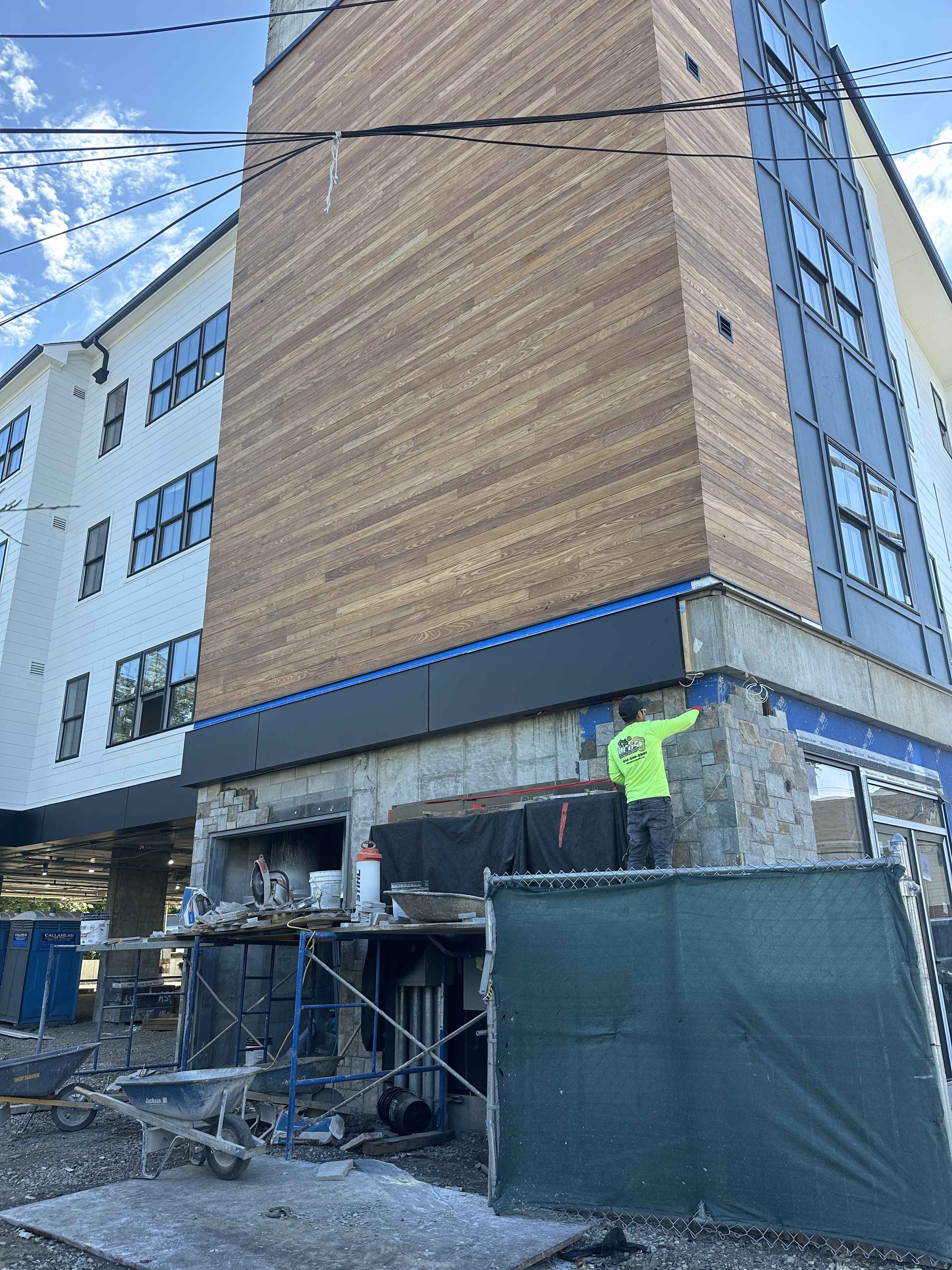Setting natural stone on commercial facade — Harrison, NY