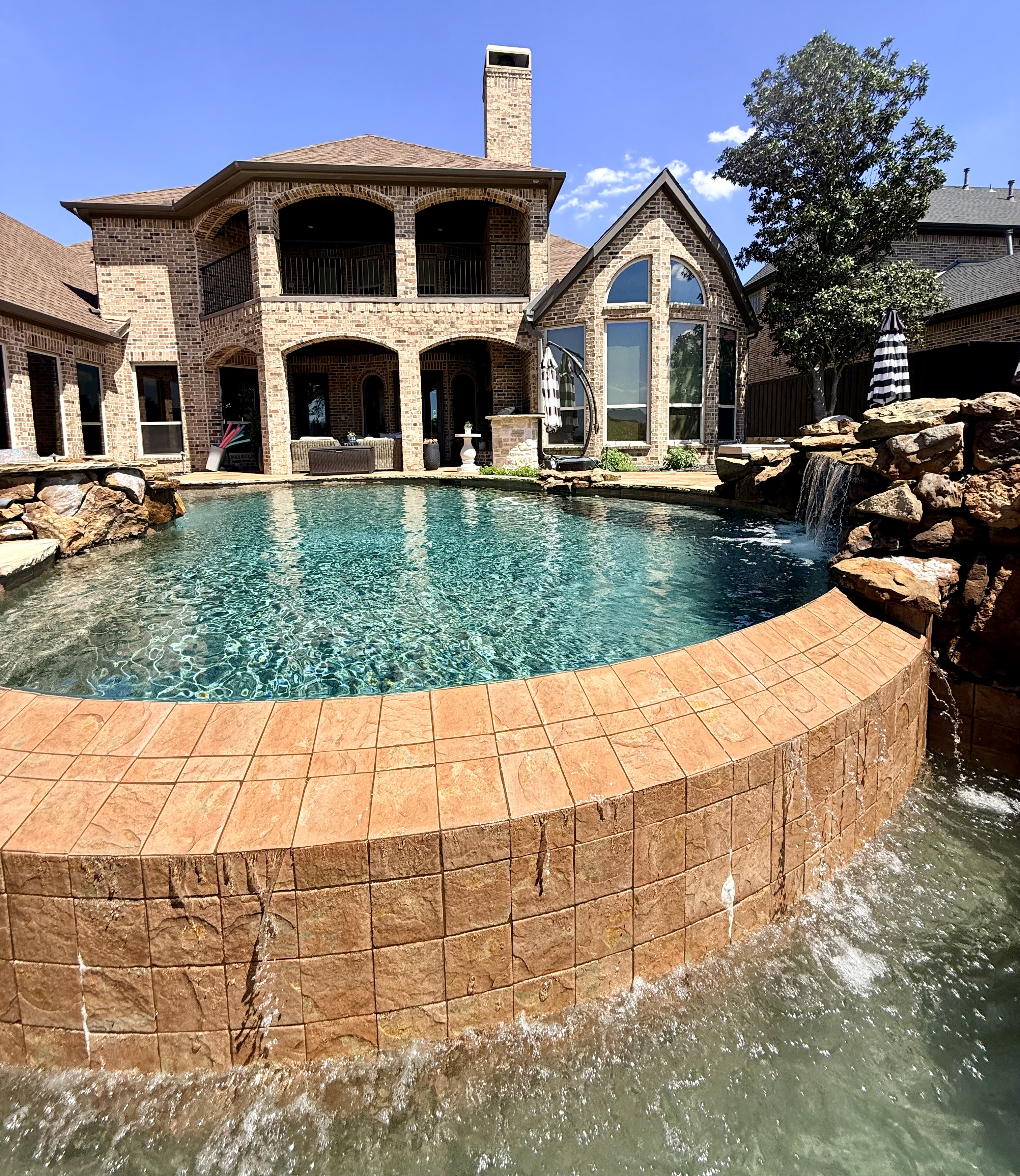 Luxury pool with rock waterfall — McKinney TX
