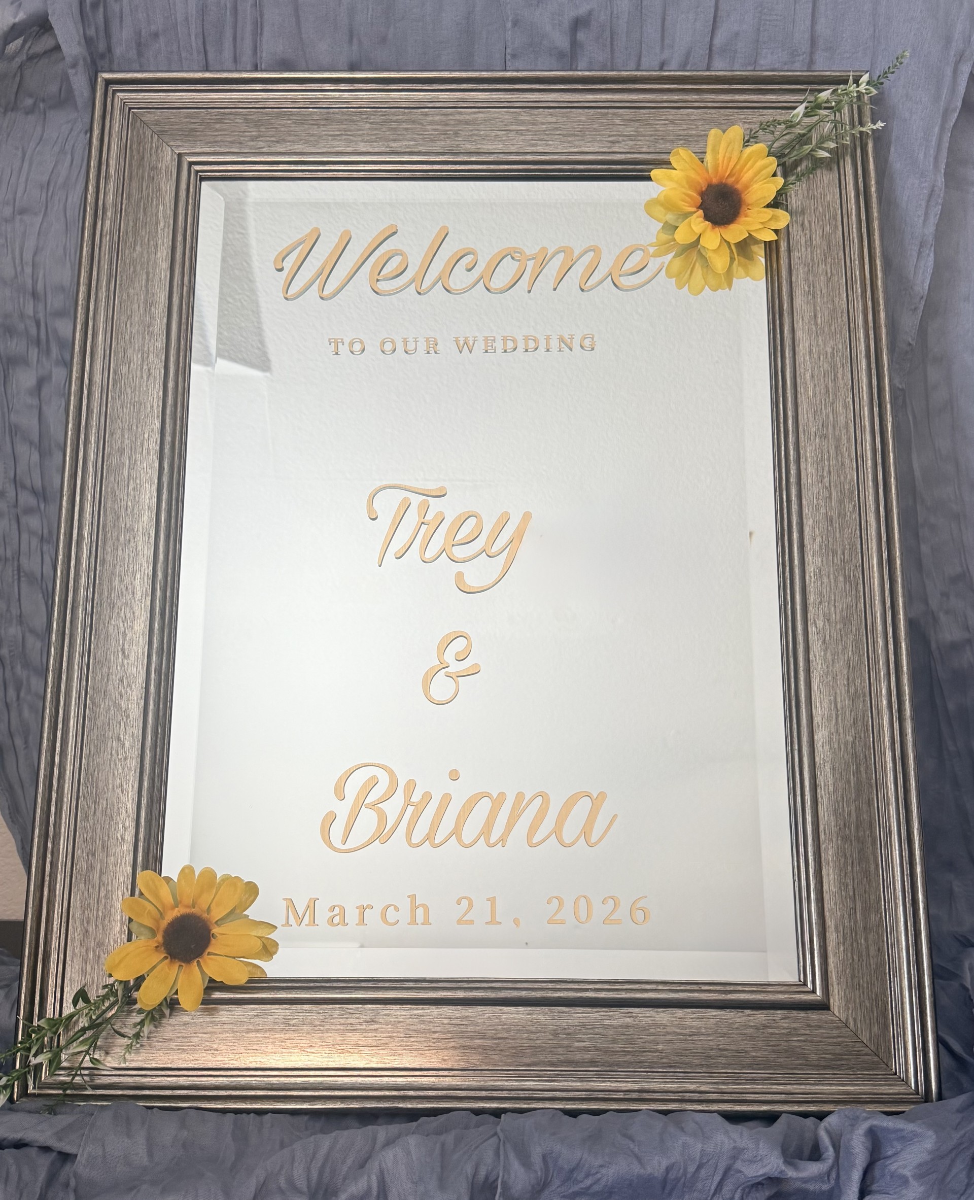Welcome mirror sign with gold calligraphy Trey and Briana March 21 2026 with sunflower accents by Petal Essence in Dallas-Fort Worth