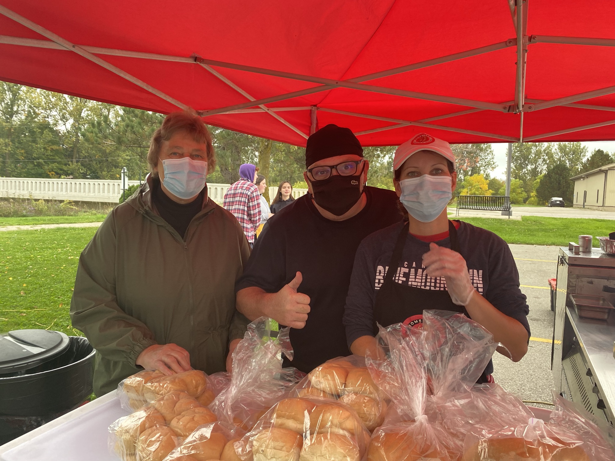 The team under the red tent with fresh buns