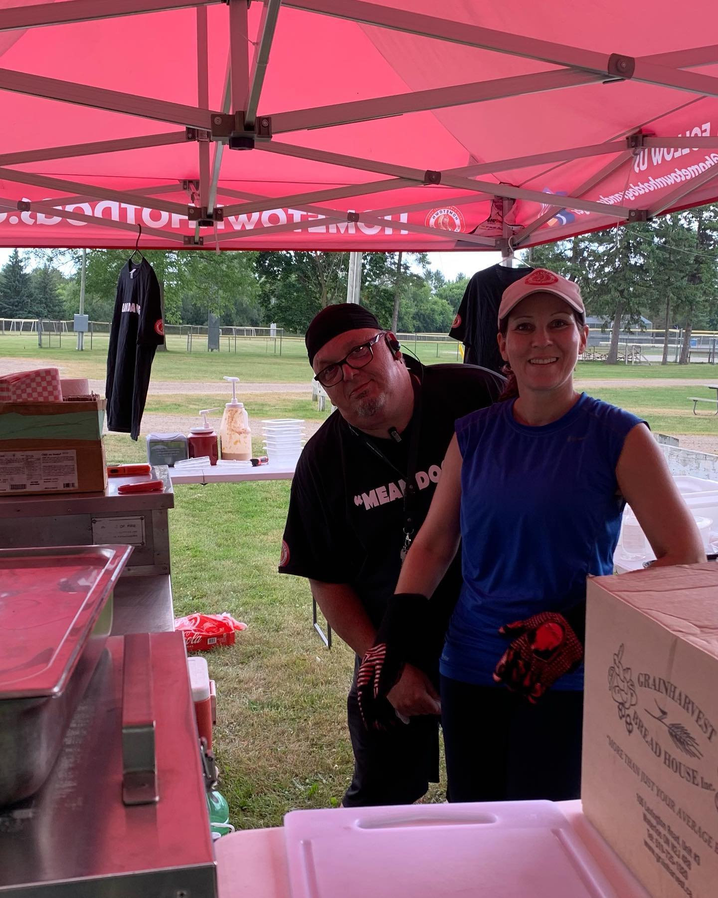 Christian and Edit behind the counter under the red tent