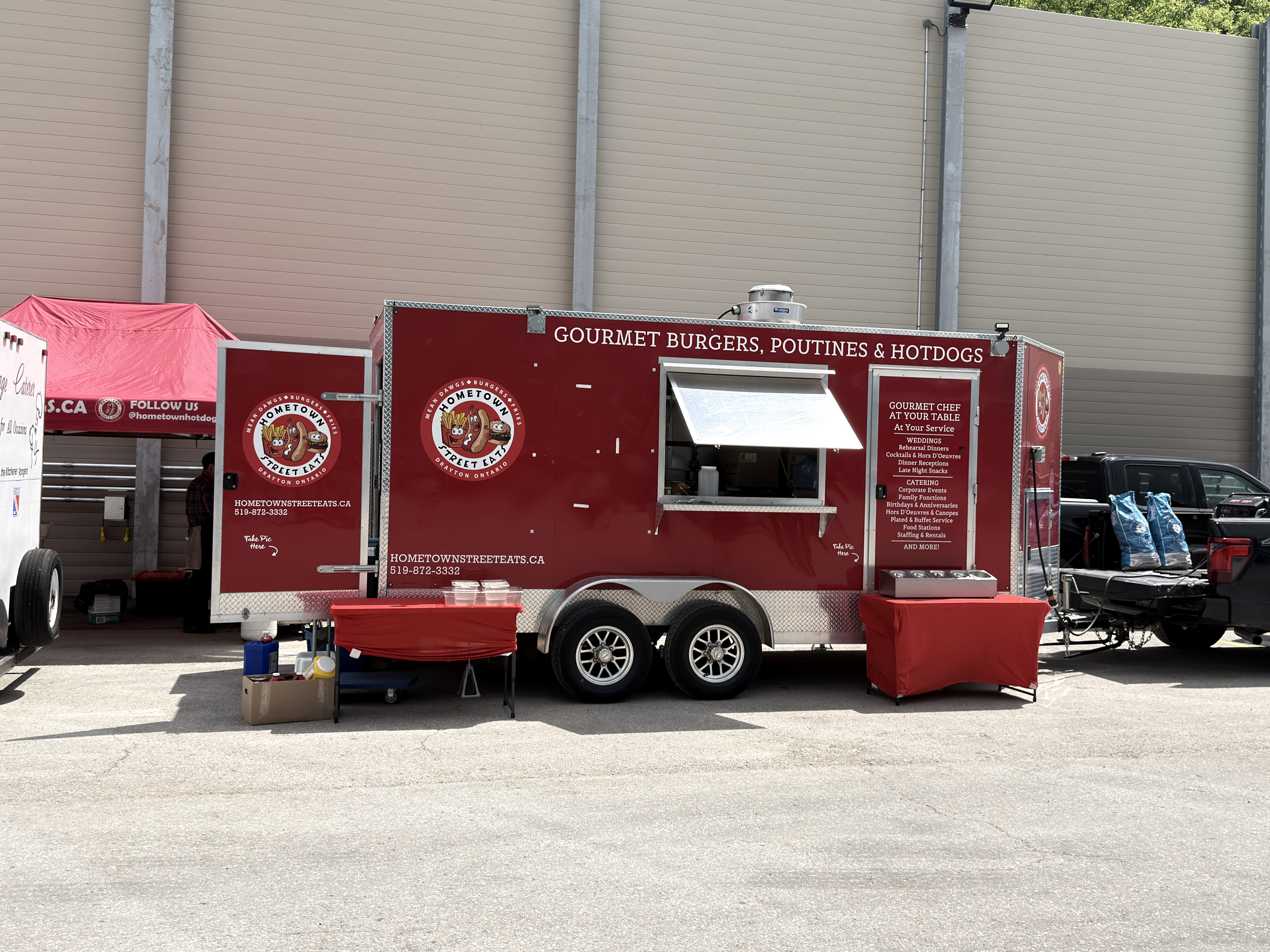 Hometown Street Eats trailer side view showing Gourmet Burgers Poutines and Hotdogs signage